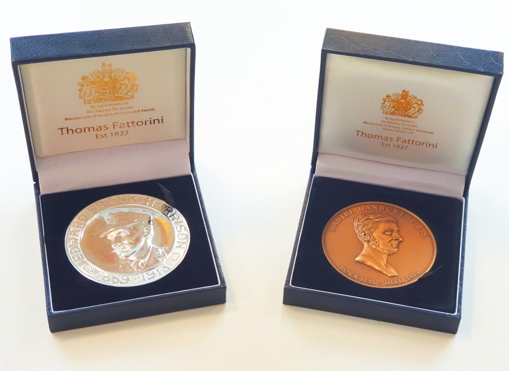 Harrison and Hanbury medals in display boxes